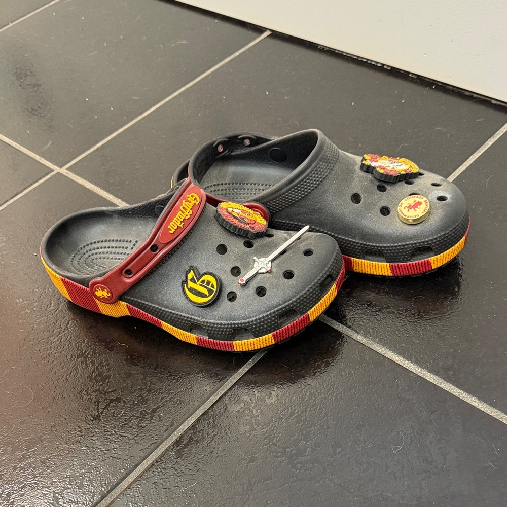 CROCS Black Kids Clogs with Red and Yellow Trim and Charms
